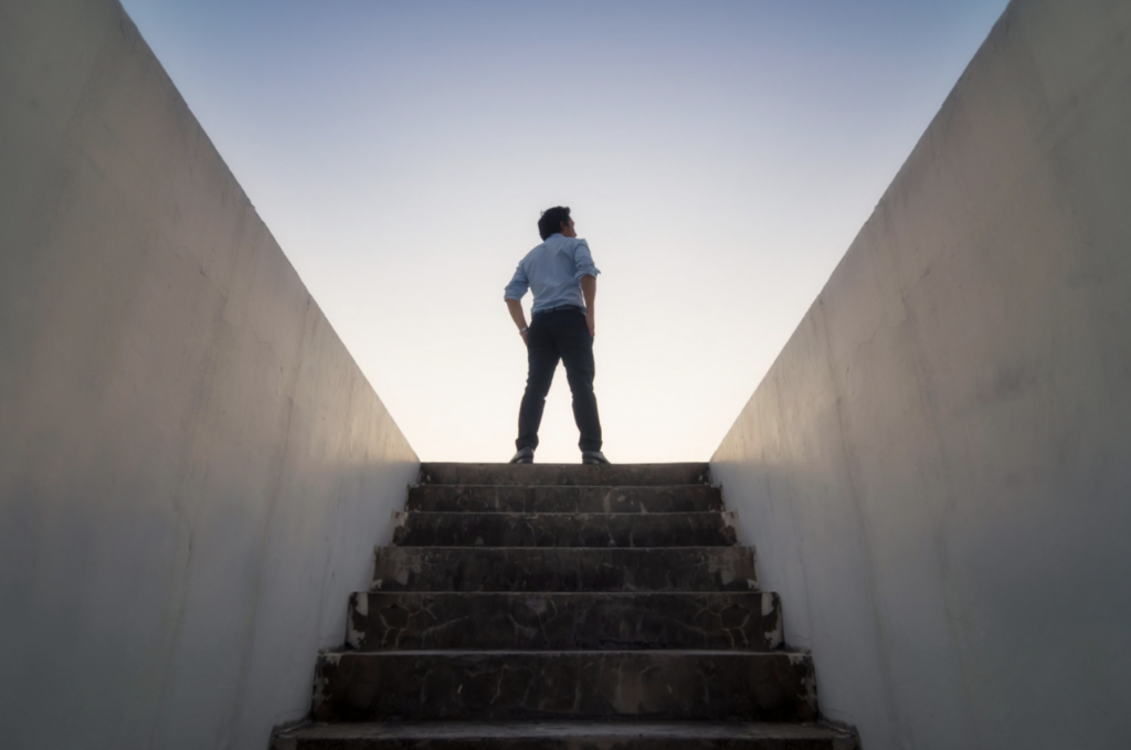 Man at top of stairs looking out