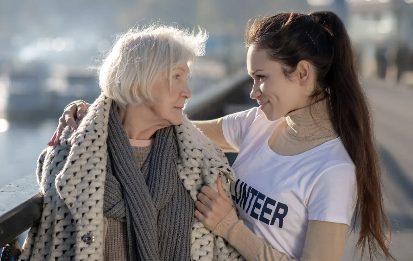 Woman being kind to an elderly woman