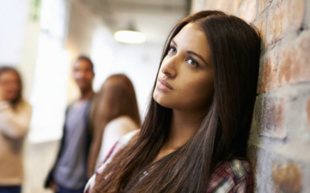 Young woman feeling judged by peers