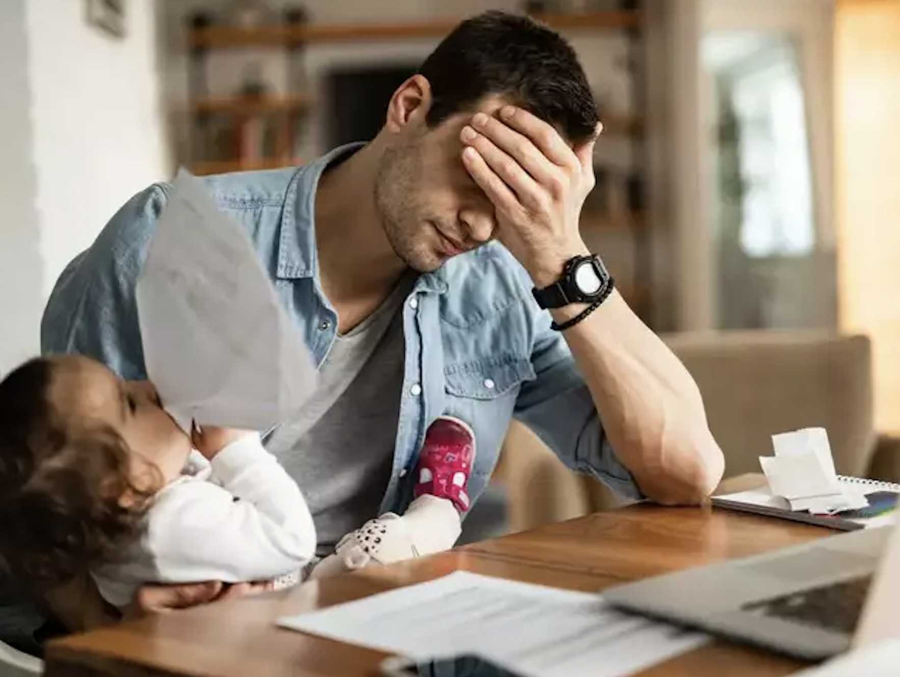 Father very fatigued while holding infant