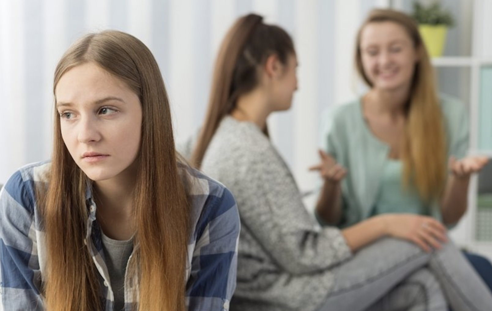 Young girl feeling left out by other girls