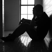 Young man sitting on floor in distress