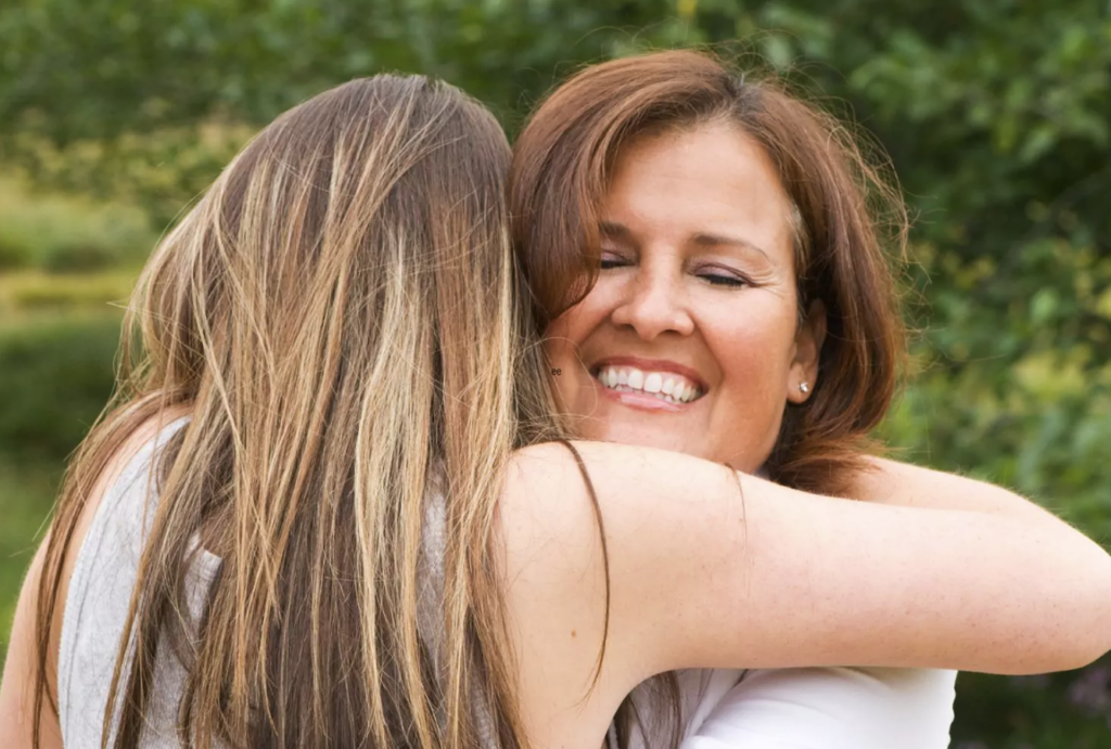 Grateful teen girl hugging her mom