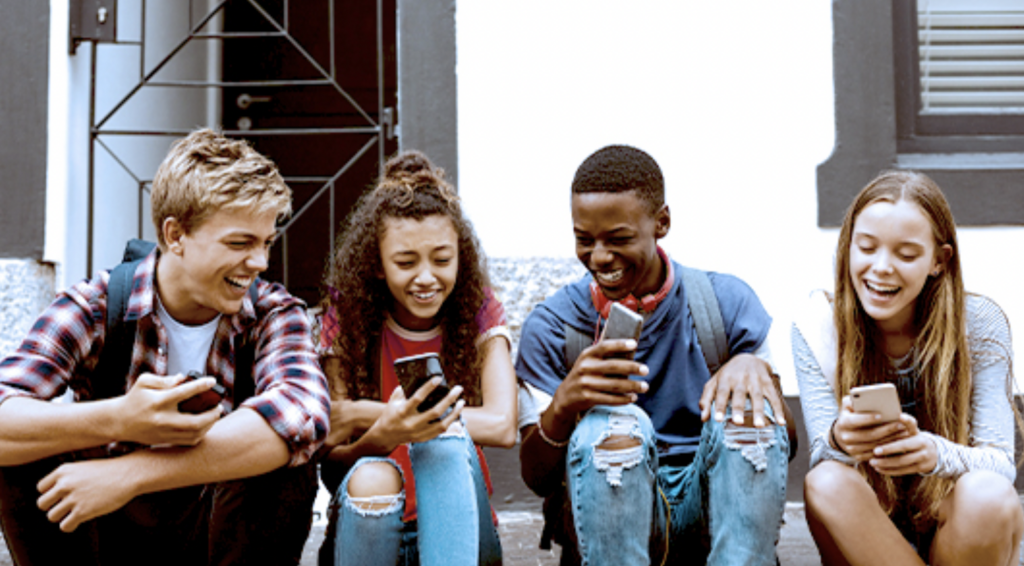 Several teens on their smart phones