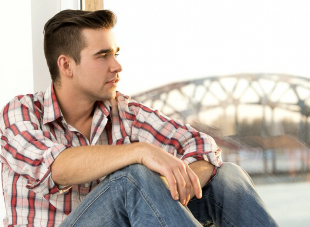 Young man sitting and pondering